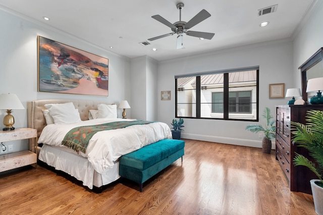 bedroom featuring ornamental molding, hardwood / wood-style floors, and ceiling fan