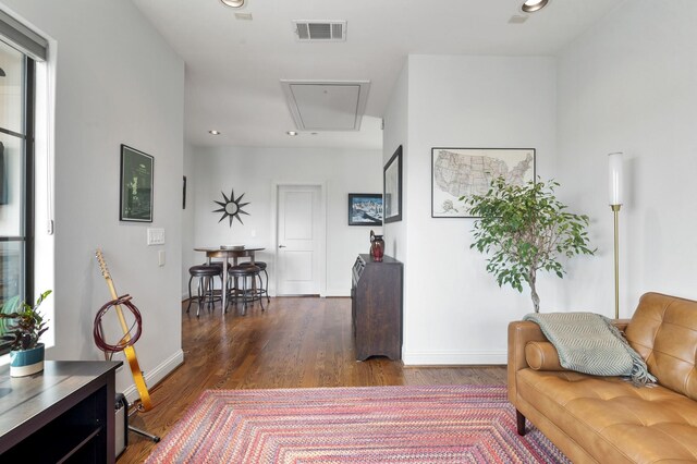 living room featuring dark hardwood / wood-style floors and a healthy amount of sunlight