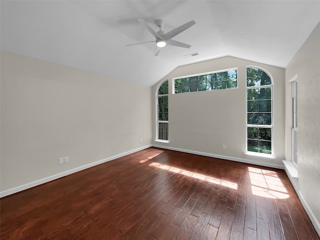 spare room with ceiling fan, vaulted ceiling, and dark hardwood / wood-style floors