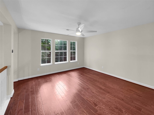 empty room featuring ceiling fan and dark hardwood / wood-style flooring