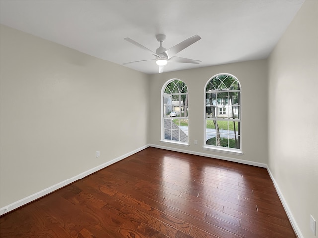 spare room featuring ceiling fan and dark wood-type flooring