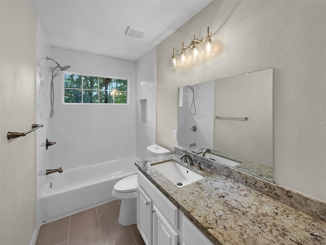 full bathroom with toilet, tiled shower / bath combo, vanity, and tile patterned floors