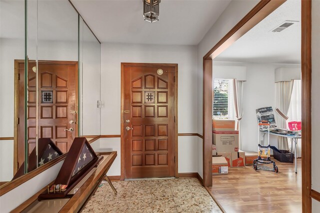 foyer entrance with light wood-type flooring