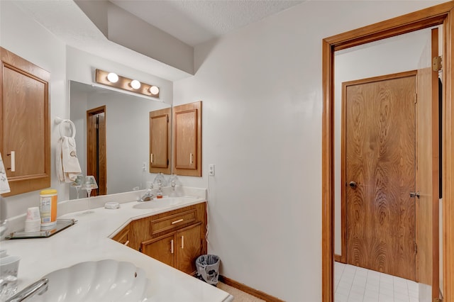 bathroom with vanity and a textured ceiling