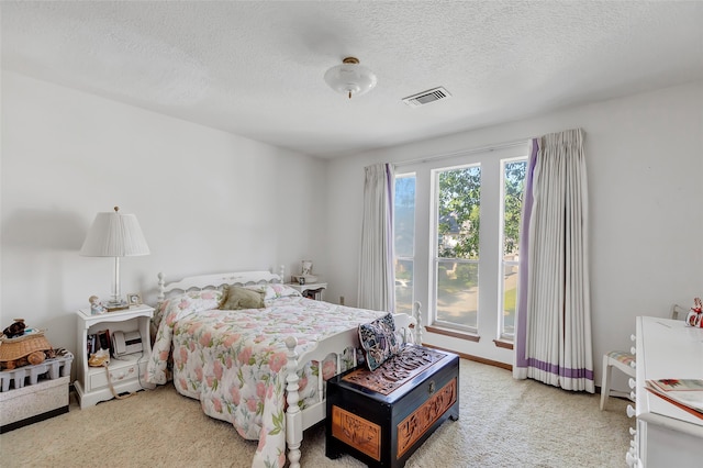 carpeted bedroom featuring a textured ceiling