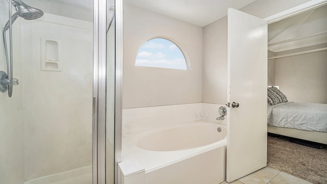 bathroom with plus walk in shower and tile patterned flooring