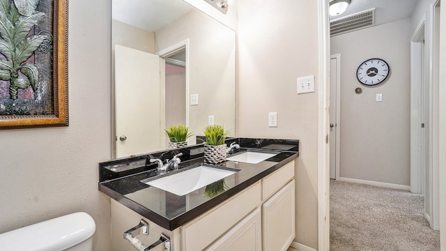 bathroom featuring toilet and vanity