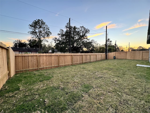 view of yard at dusk