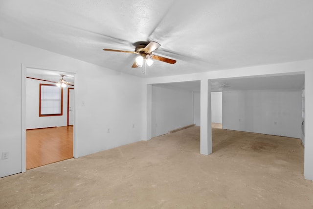 below grade area with a ceiling fan