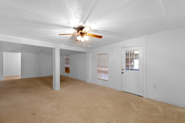 interior space with a ceiling fan and a textured ceiling