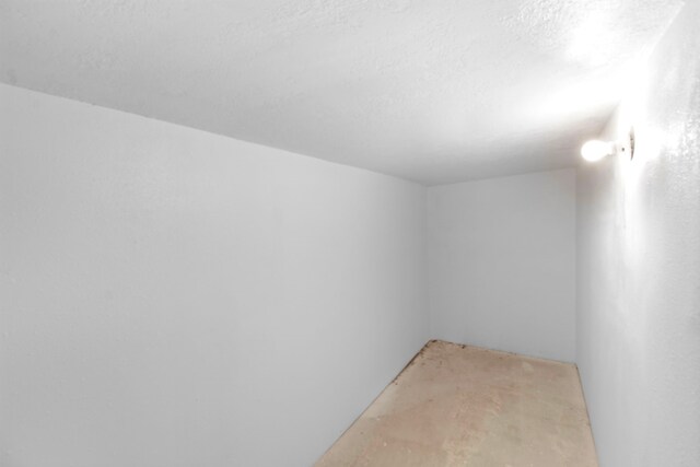 empty room featuring unfinished concrete flooring and a textured ceiling