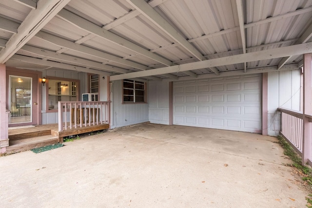 garage featuring covered porch and concrete driveway