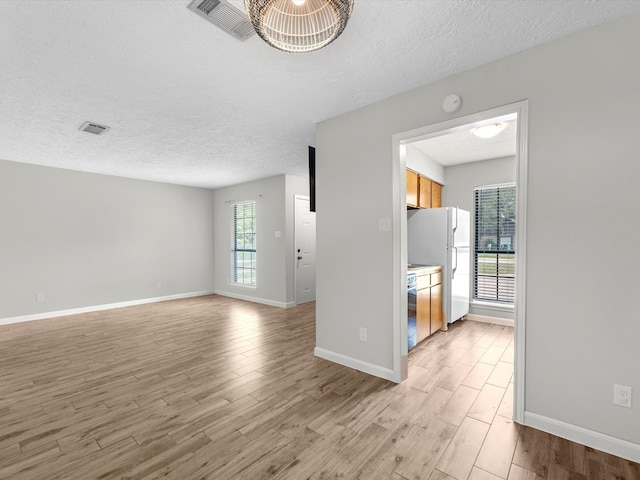 interior space featuring a textured ceiling and hardwood / wood-style flooring