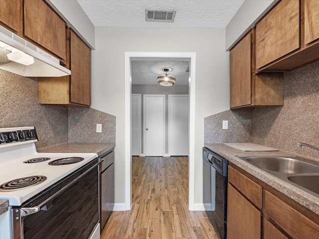 kitchen with extractor fan, decorative backsplash, white electric range oven, and a textured ceiling