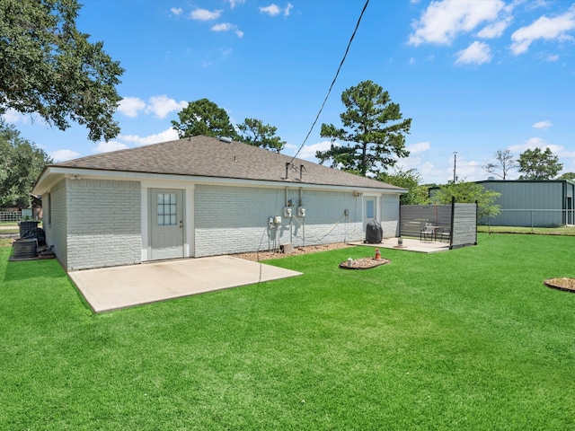 rear view of house featuring a patio area, a fire pit, and a lawn