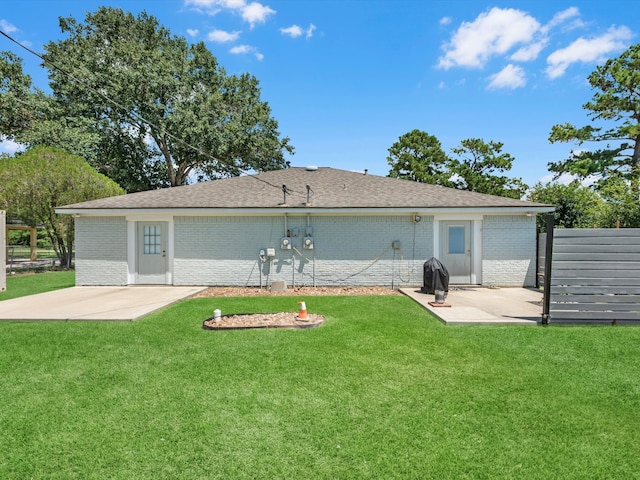 rear view of house featuring a patio and a yard