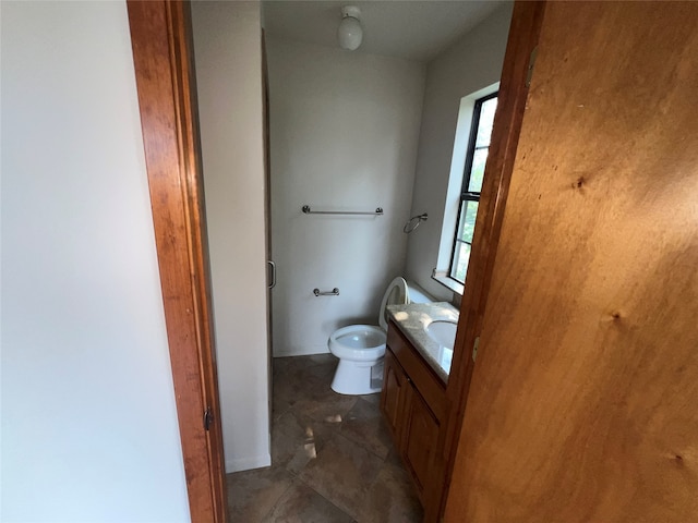 bathroom featuring toilet, vanity, and tile patterned floors