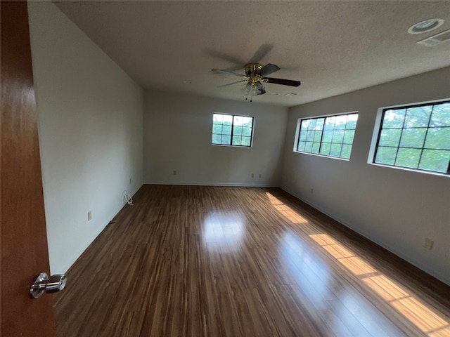 unfurnished room featuring ceiling fan, a textured ceiling, and dark wood-type flooring