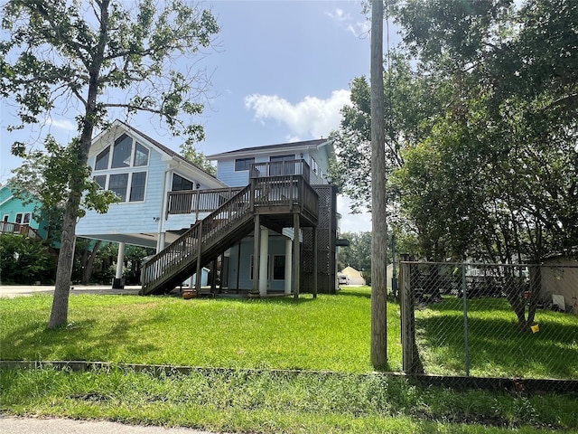 back of property featuring a yard and a wooden deck