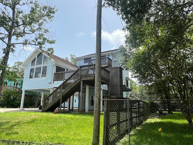 rear view of property featuring a yard