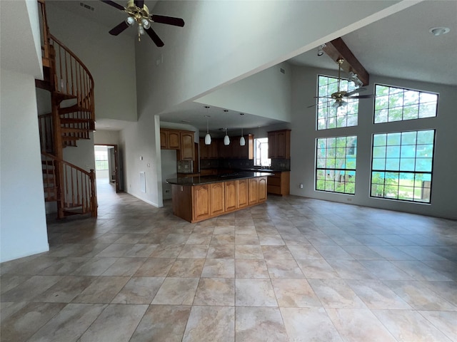 interior space with ceiling fan, beam ceiling, high vaulted ceiling, and light tile patterned flooring