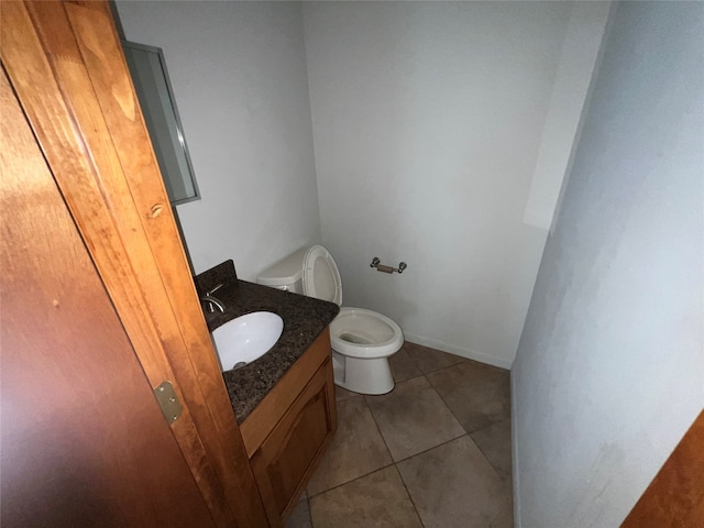 bathroom featuring tile patterned floors, vanity, and toilet