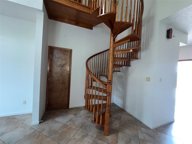 stairs featuring tile patterned floors