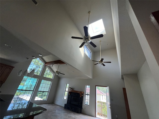 living room featuring a towering ceiling and plenty of natural light