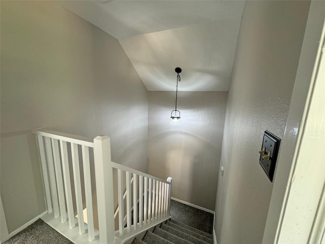 stairs featuring carpet floors and lofted ceiling