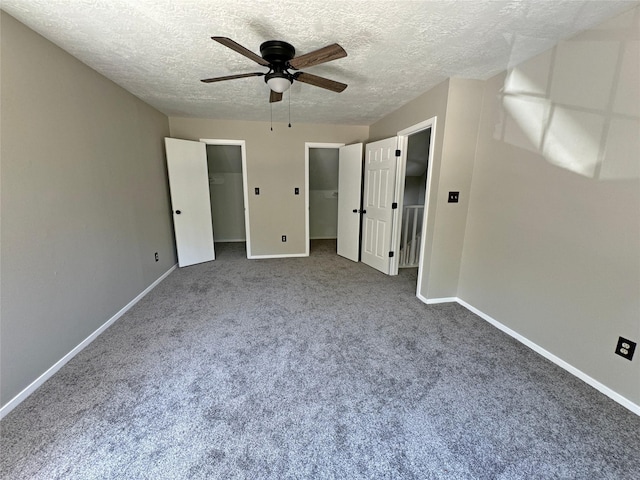 unfurnished bedroom with carpet, a textured ceiling, and ceiling fan