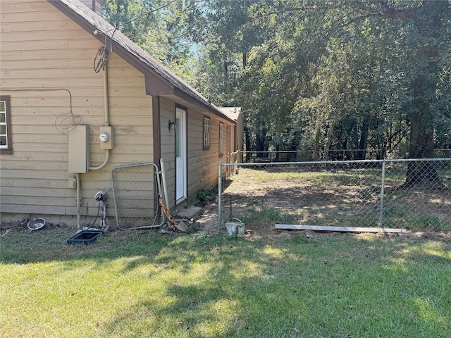 view of side of property with a yard