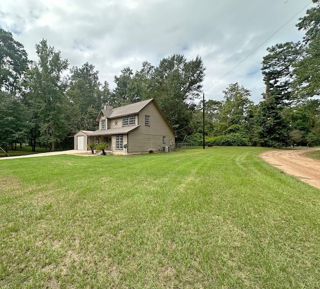 view of side of property featuring a yard and a garage