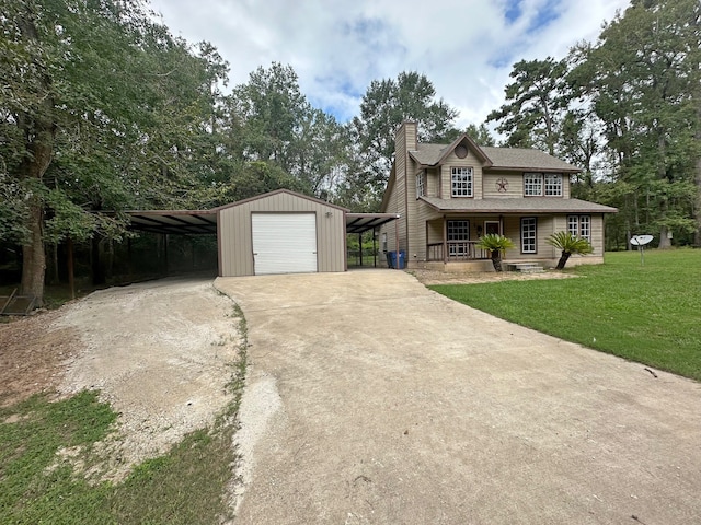 view of front facade featuring a front yard, a carport, covered porch, a garage, and an outdoor structure