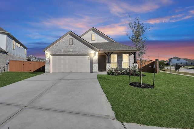 view of front of home featuring a lawn and a garage