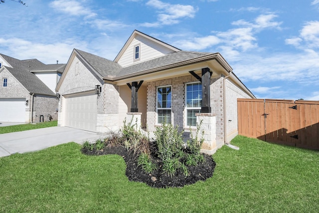 view of front of home featuring a front lawn, covered porch, and a garage