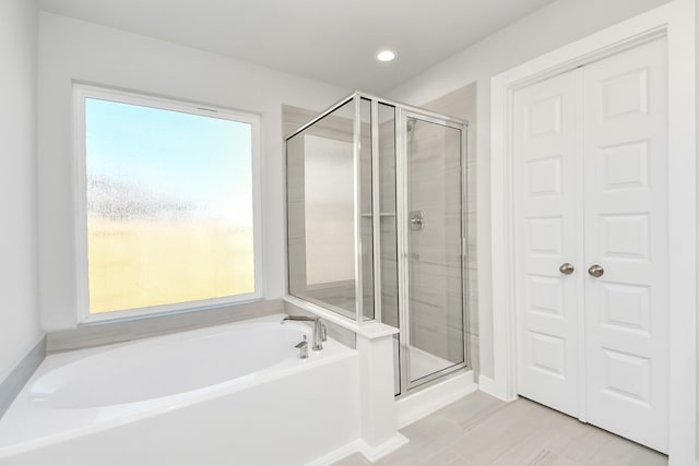 bathroom with tile patterned floors and plus walk in shower