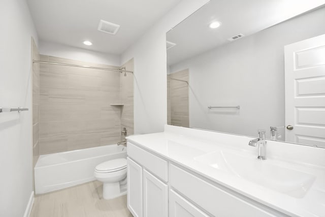 full bathroom with vanity, toilet, and tiled shower / bath combo