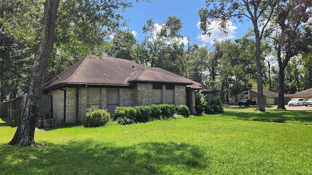 view of home's exterior with a lawn