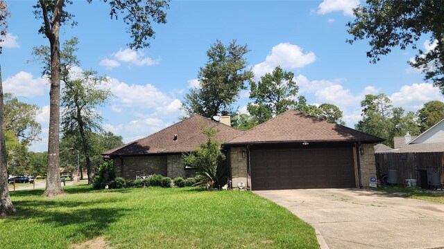 ranch-style house featuring a garage and a front lawn