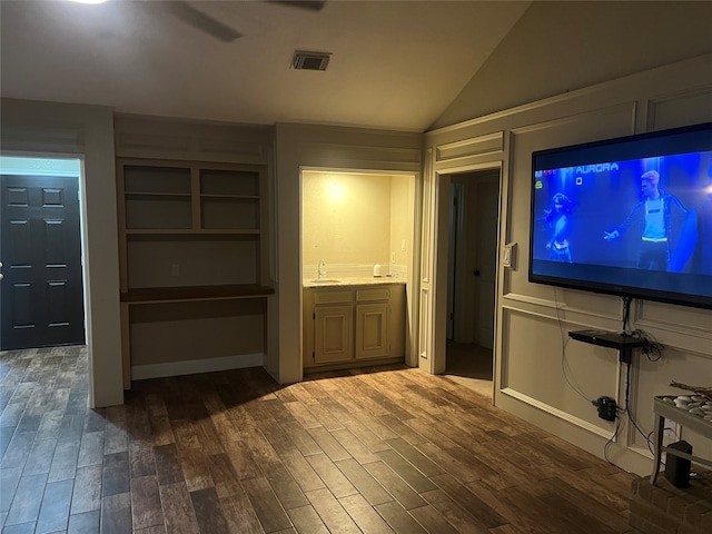 interior space with dark hardwood / wood-style flooring, sink, and lofted ceiling