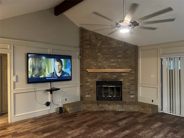 unfurnished living room with ceiling fan, dark hardwood / wood-style flooring, lofted ceiling with beams, and a brick fireplace