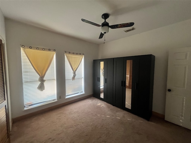 unfurnished bedroom featuring ceiling fan and carpet