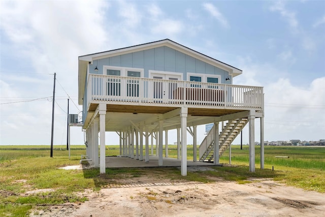 coastal home with a carport, a deck, and central AC