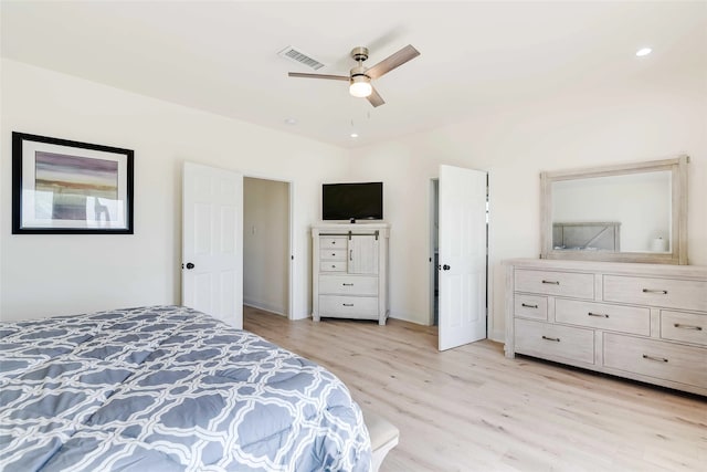 bedroom with light hardwood / wood-style floors and ceiling fan