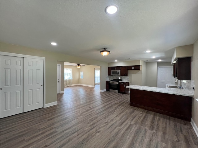 kitchen featuring sink, stainless steel appliances, dark hardwood / wood-style floors, and dark brown cabinetry