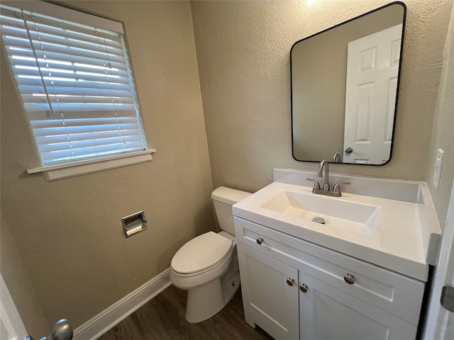 bathroom featuring vanity, hardwood / wood-style floors, and toilet