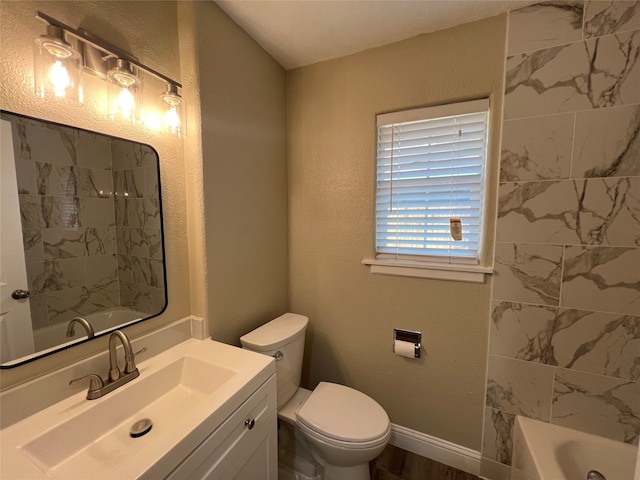 full bathroom featuring tiled shower / bath, toilet, and vanity