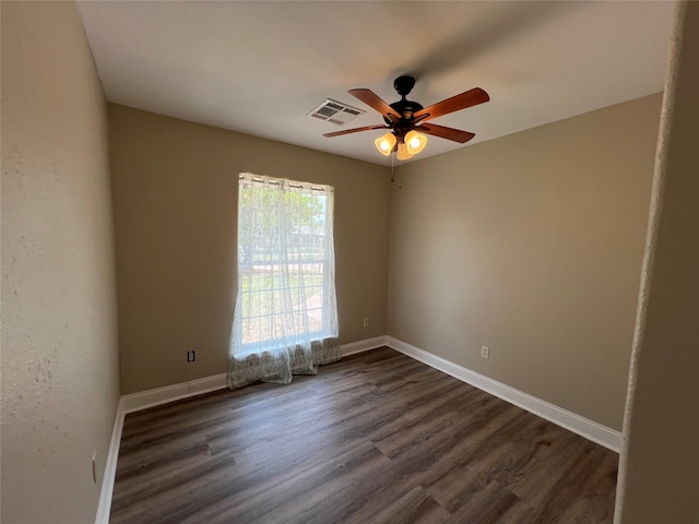 empty room with ceiling fan and dark hardwood / wood-style floors