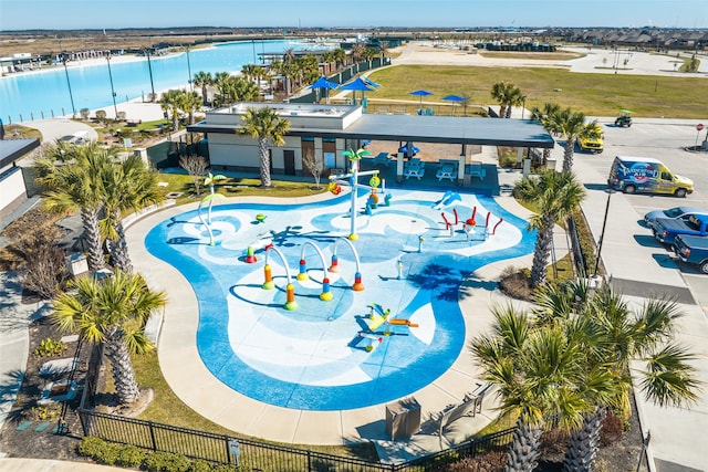 view of pool featuring a patio and a water view