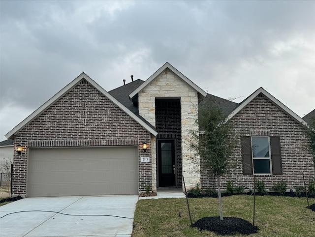 view of front of house featuring a garage and a front lawn